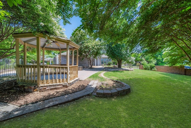 view of yard with a gazebo and a wooden deck