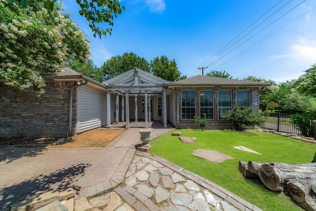 back of house with a patio and a lawn