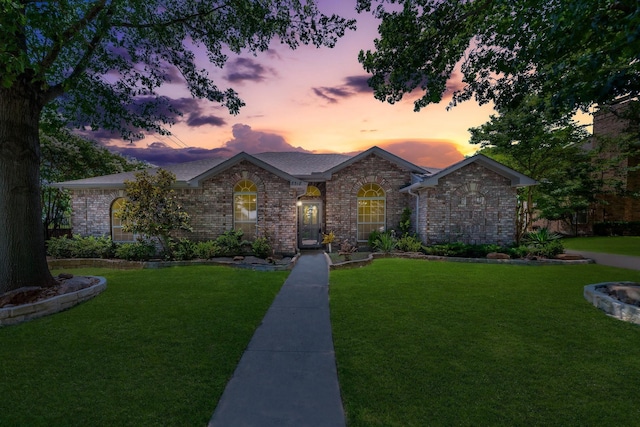 ranch-style house featuring a yard