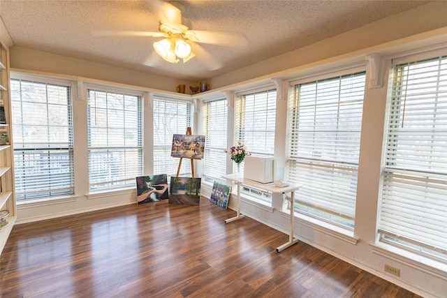 interior space with ceiling fan, a healthy amount of sunlight, a textured ceiling, and dark wood-type flooring