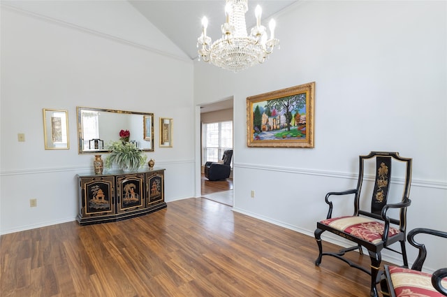 sitting room featuring hardwood / wood-style floors, a notable chandelier, and high vaulted ceiling