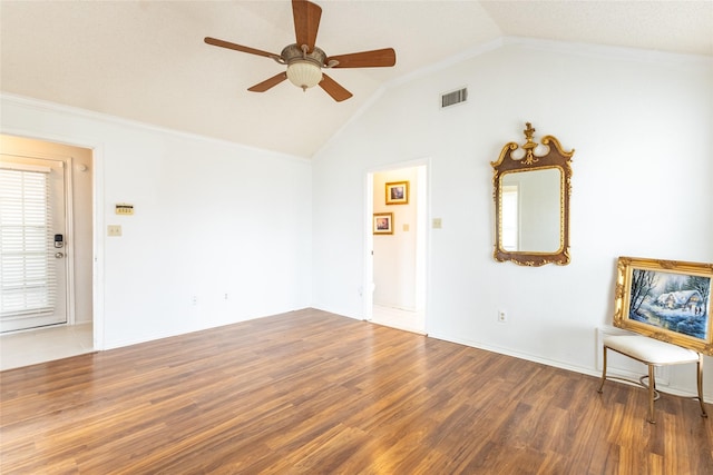 unfurnished room with ceiling fan, dark hardwood / wood-style floors, lofted ceiling, and ornamental molding