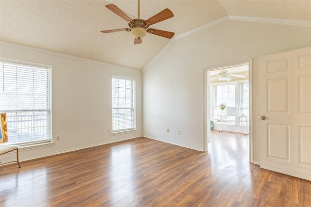 spare room with ceiling fan, dark hardwood / wood-style floors, a textured ceiling, vaulted ceiling, and ornamental molding