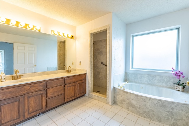 bathroom featuring vanity, shower with separate bathtub, a textured ceiling, and tile patterned floors