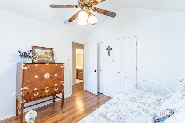 bedroom featuring dark hardwood / wood-style floors, ceiling fan, and lofted ceiling