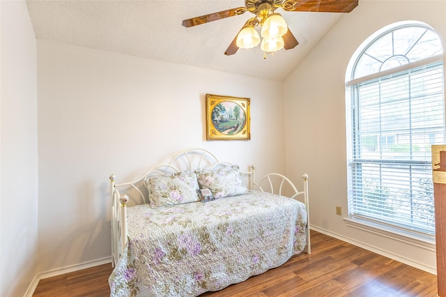 bedroom featuring ceiling fan, lofted ceiling, and dark wood-type flooring