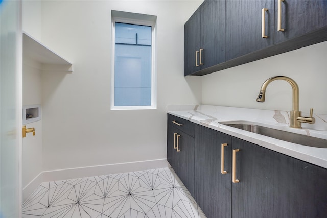 washroom featuring cabinets, sink, and washer hookup