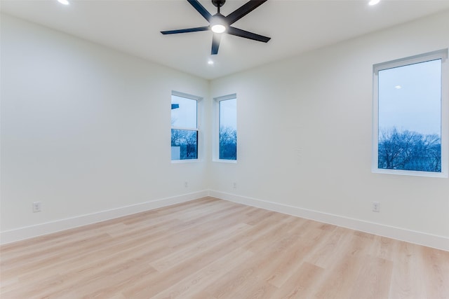 empty room featuring ceiling fan and light hardwood / wood-style floors