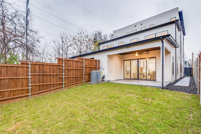 back of house with a lawn, a patio area, ceiling fan, and cooling unit