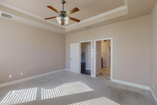 unfurnished bedroom with a raised ceiling, ceiling fan, and crown molding