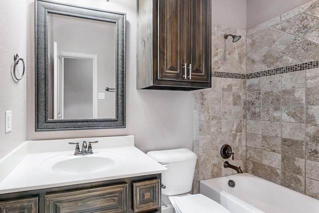 full bathroom featuring vanity, tiled shower / bath combo, and toilet