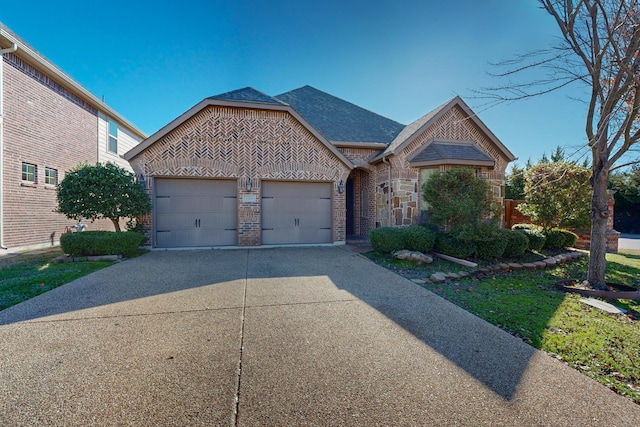 view of front of home with a garage, driveway, brick siding, and roof with shingles