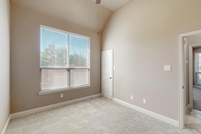 unfurnished room with light colored carpet, ceiling fan, and lofted ceiling