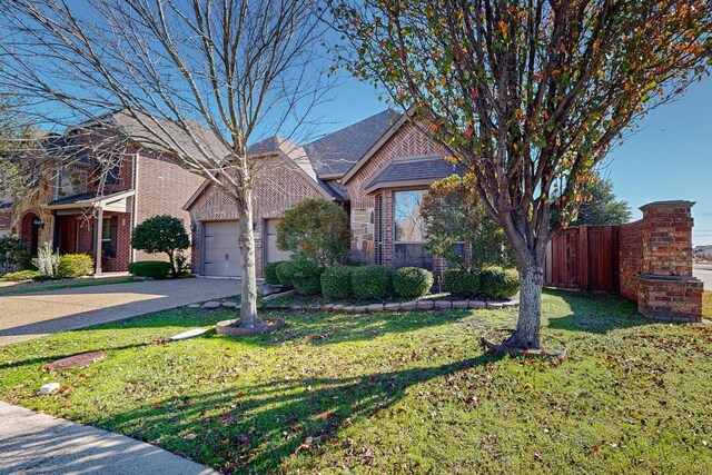 view of front facade with a front lawn and a garage