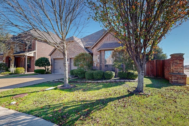 view of front of house featuring a garage and a front yard