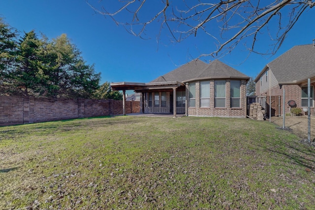 rear view of property featuring a yard