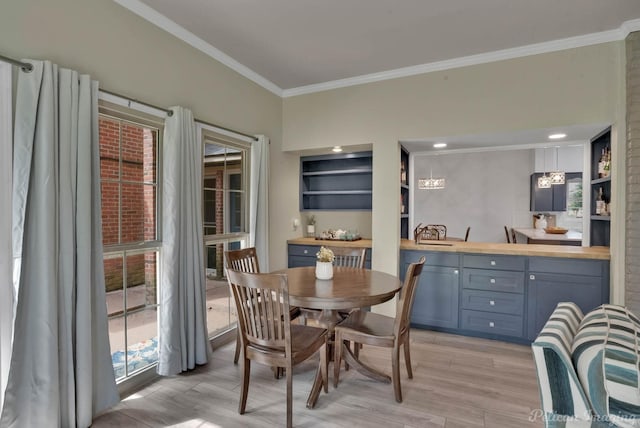 dining area with ornamental molding and a healthy amount of sunlight