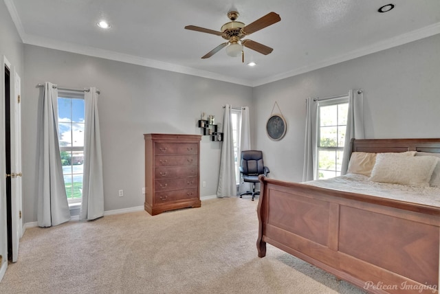 bedroom with multiple windows, ceiling fan, and light colored carpet