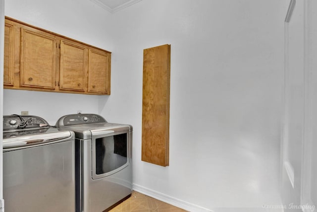 laundry area featuring cabinets, separate washer and dryer, and crown molding