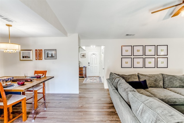 living room featuring ceiling fan and wood-type flooring