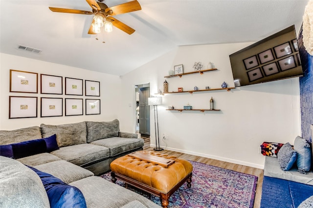 living room featuring hardwood / wood-style flooring, ceiling fan, and lofted ceiling