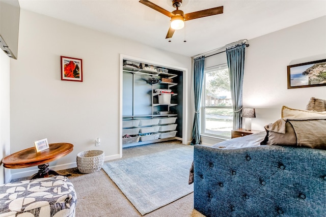 carpeted bedroom featuring ceiling fan and a closet