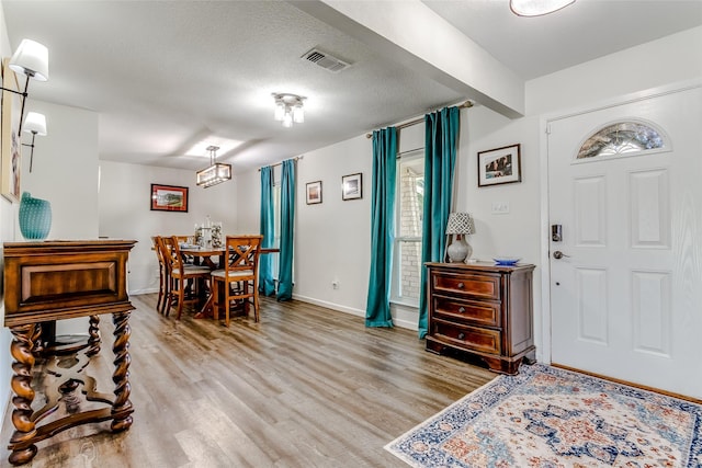 entrance foyer featuring hardwood / wood-style floors and a textured ceiling