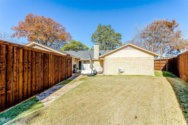 back of house with a lawn