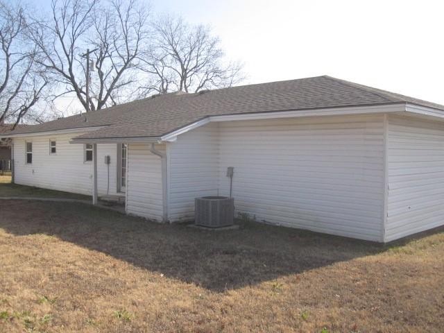 exterior space featuring a lawn and central AC