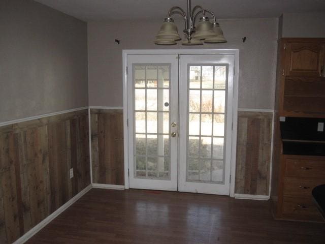 doorway to outside with a chandelier, dark hardwood / wood-style flooring, and french doors