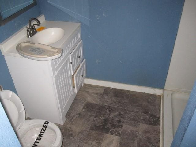 bathroom featuring vanity and toilet