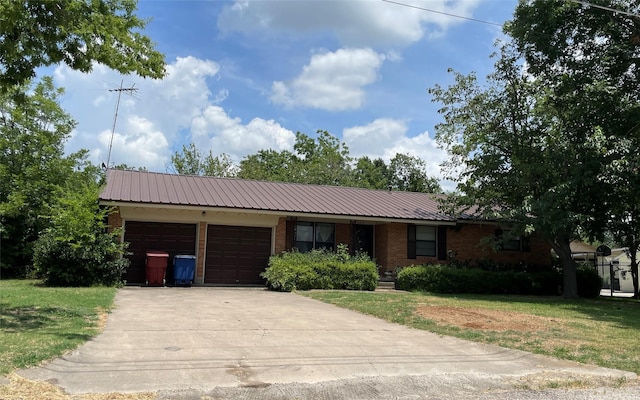 ranch-style home with a garage and a front lawn