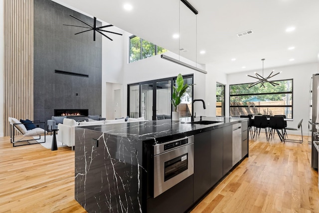 kitchen with pendant lighting, a large island, and appliances with stainless steel finishes