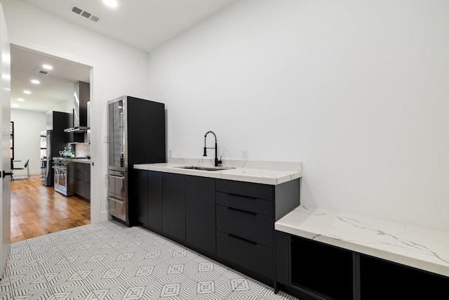 bathroom with hardwood / wood-style floors and sink