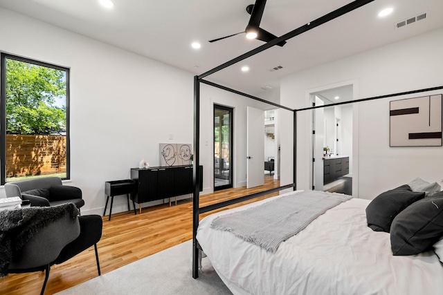 bedroom with light wood-type flooring, ensuite bathroom, and ceiling fan