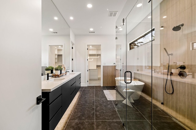 bathroom featuring tile patterned flooring, vanity, and shower with separate bathtub