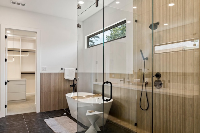 bathroom featuring tile patterned floors and independent shower and bath