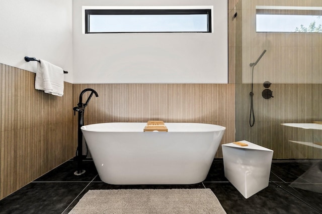 bathroom featuring tile patterned flooring, wooden walls, and independent shower and bath