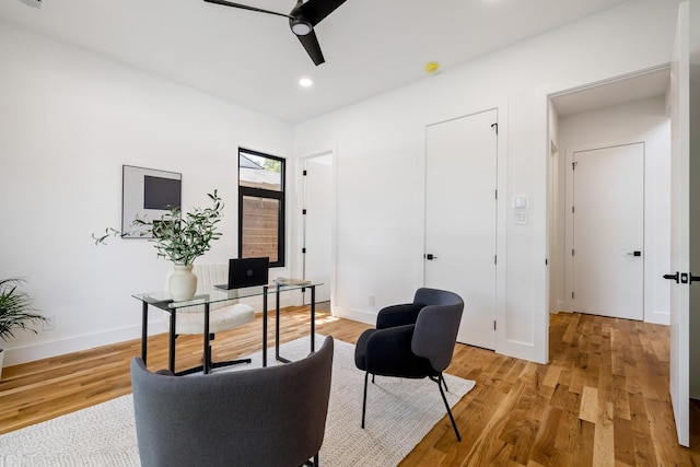 office area with light hardwood / wood-style flooring and ceiling fan