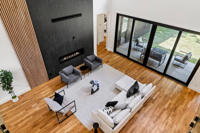 living room featuring a wealth of natural light, a fireplace, and wood-type flooring