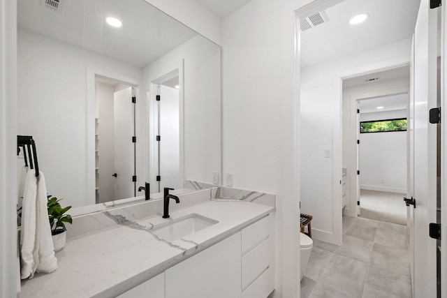 bathroom featuring vanity and toilet