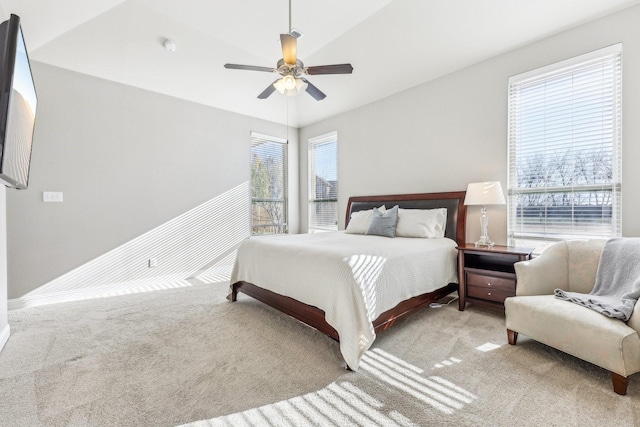 bedroom featuring multiple windows, ceiling fan, and carpet