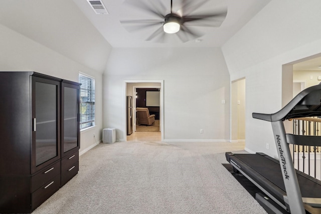 exercise room with light colored carpet, vaulted ceiling, and ceiling fan