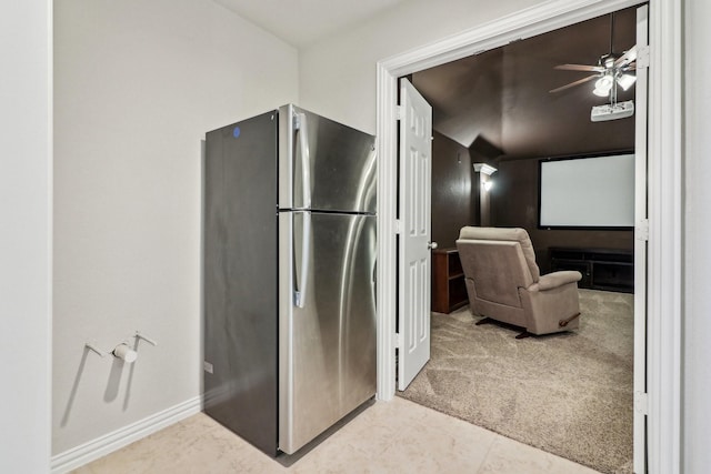 kitchen with stainless steel fridge, light colored carpet, and ceiling fan