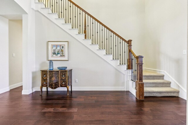 stairway with hardwood / wood-style floors