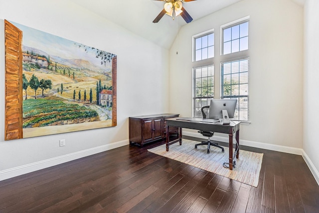 office featuring dark hardwood / wood-style floors, ceiling fan, and a towering ceiling