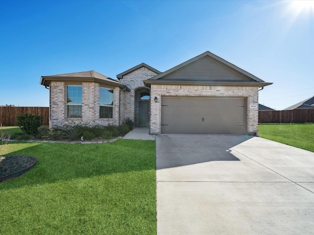 view of front of property with a garage and a front yard