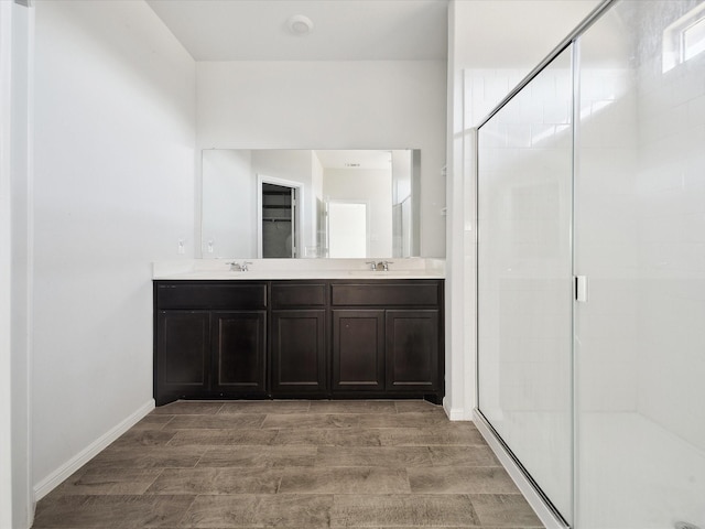 bathroom featuring vanity and a shower with shower door