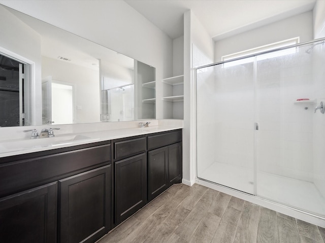 bathroom featuring vanity and a shower with shower door