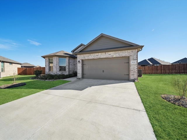 ranch-style house featuring central AC, a front yard, and a garage